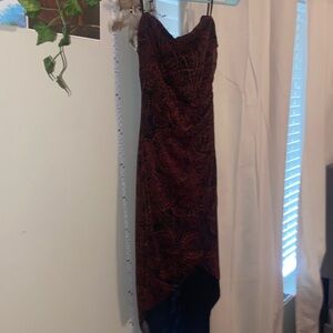 Black base skinny strap dress. Short in the front and longer tail in the back.